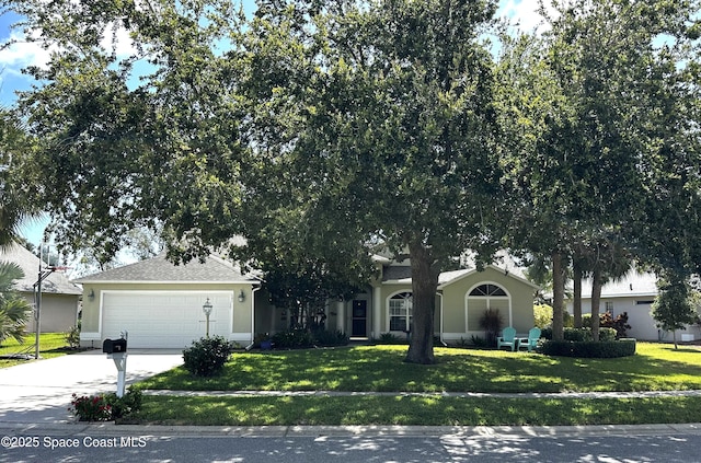 585 Lake Victoria Cir, Melbourne, FL 32940 - view of property hidden behind natural elements with driveway, a front lawn, a garage, and stucco siding