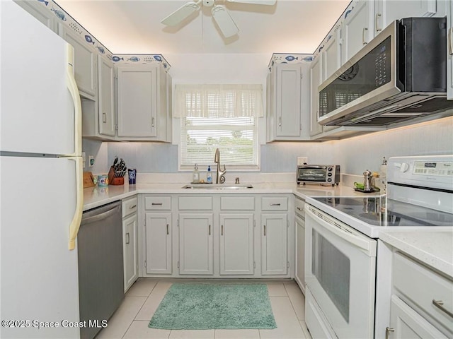 57 Woodland Dr Unit 201, Vero Beach, FL 32962 - kitchen featuring appliances with stainless steel finishes, a ceiling fan, light countertops, and light tile patterned flooring