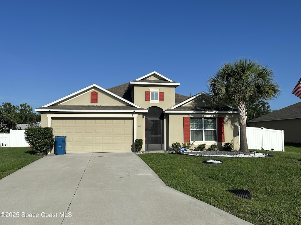 412 Charlotta Ave SE, Palm Bay, FL 32909 - traditional-style house featuring stucco siding, concrete driveway, and an attached garage