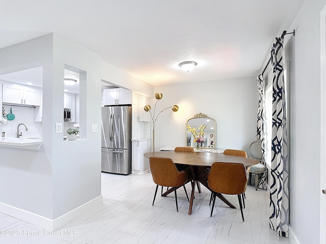 432 N Neptune Dr, Satellite Beach, FL 32937 - dining area with baseboards and light marble finish floors