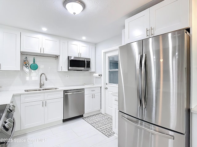432 N Neptune Dr, Satellite Beach, FL 32937 - kitchen featuring stainless steel appliances, white cabinetry, light countertops, and recessed lighting