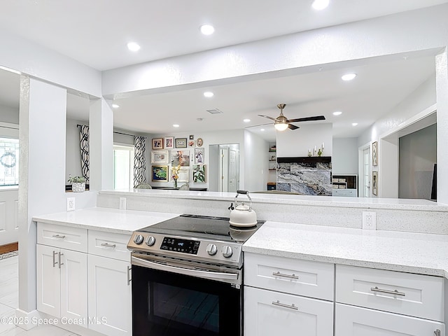 432 N Neptune Dr, Satellite Beach, FL 32937 - kitchen with electric range, recessed lighting, light stone counters, white cabinets, and a ceiling fan