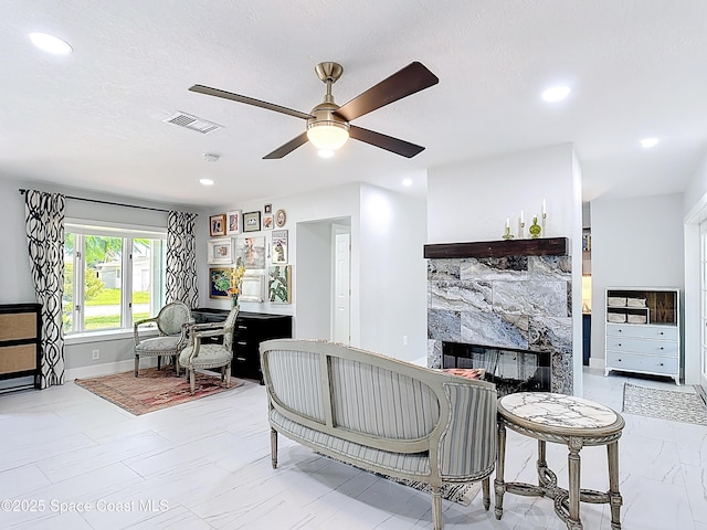 432 N Neptune Dr, Satellite Beach, FL 32937 - living room featuring a multi sided fireplace, ceiling fan, recessed lighting, and marble finish flooring