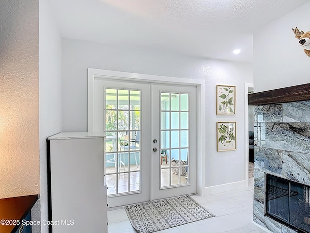432 N Neptune Dr, Satellite Beach, FL 32937 - entryway featuring a fireplace and french doors