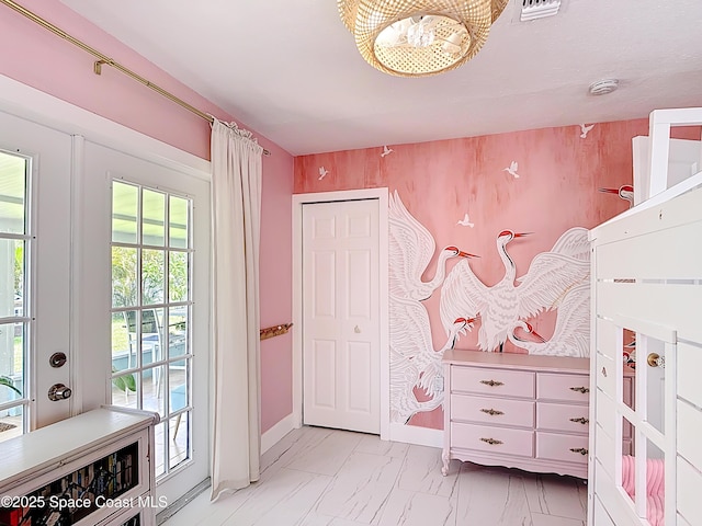 432 N Neptune Dr, Satellite Beach, FL 32937 - bedroom featuring a chandelier, access to outside, and light marble finish flooring