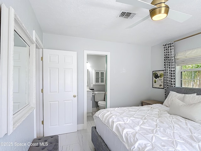 432 N Neptune Dr, Satellite Beach, FL 32937 - bedroom with marble look tile flooring, ensuite bath, and ceiling fan