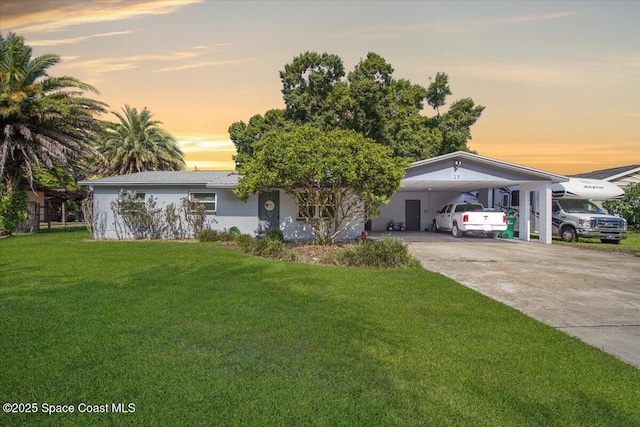 13 Lee St, Cocoa, FL 32926 - view of front of home with driveway, a lawn, and an attached carport