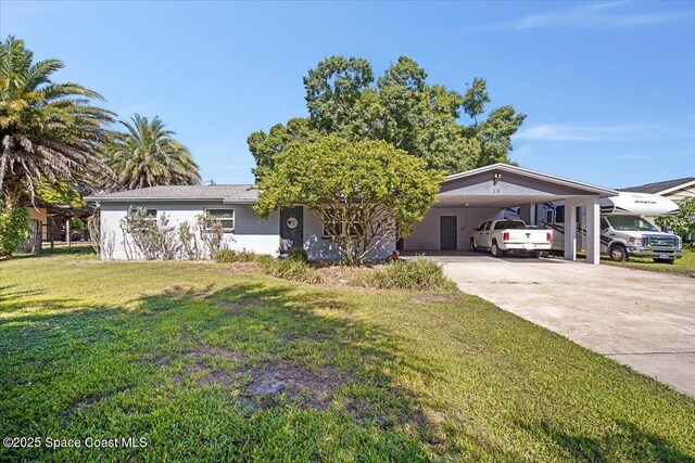 13 Lee St, Cocoa, FL 32926 - view of front of home featuring driveway, a front lawn, and an attached carport