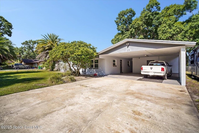 13 Lee St, Cocoa, FL 32926 - view of front of house featuring driveway, a front lawn, and an attached carport