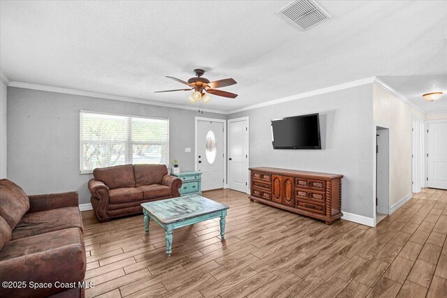 13 Lee St, Cocoa, FL 32926 - living area with ornamental molding, wood finished floors, ceiling fan, and a textured ceiling