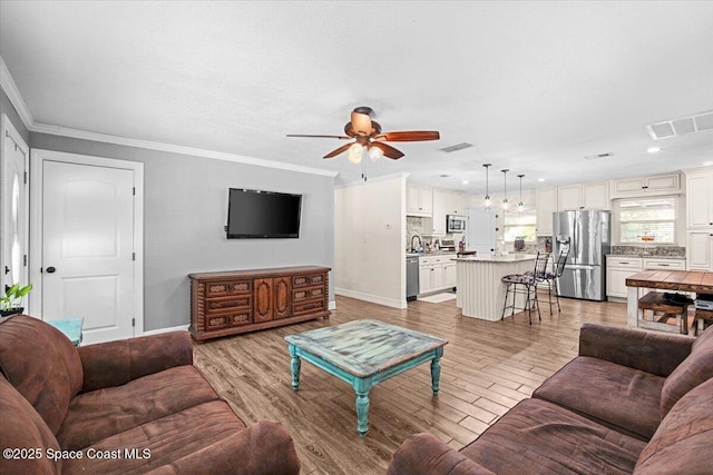 13 Lee St, Cocoa, FL 32926 - living area featuring a ceiling fan, light wood finished floors, ornamental molding, and recessed lighting