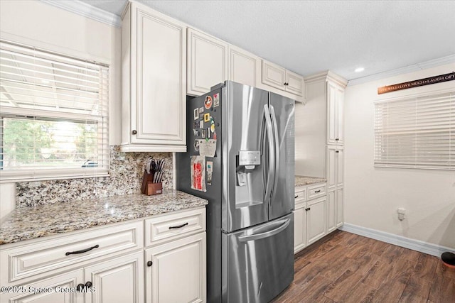 13 Lee St, Cocoa, FL 32926 - kitchen with stainless steel refrigerator with ice dispenser, dark wood finished floors, ornamental molding, tasteful backsplash, and light stone countertops