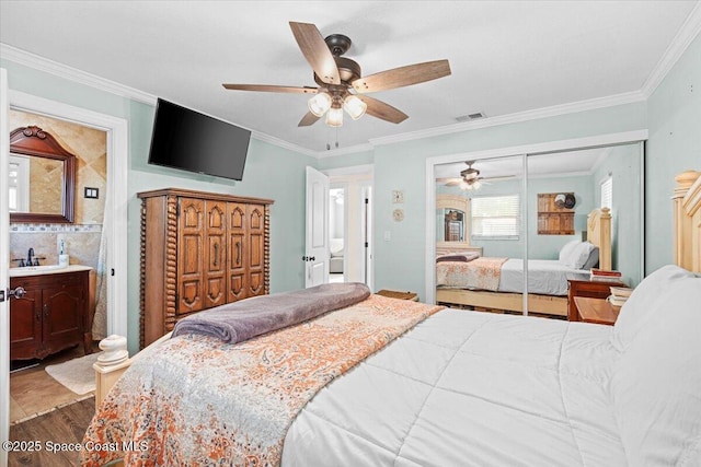 13 Lee St, Cocoa, FL 32926 - bedroom featuring wood finished floors, crown molding, a closet, ceiling fan, and ensuite bath