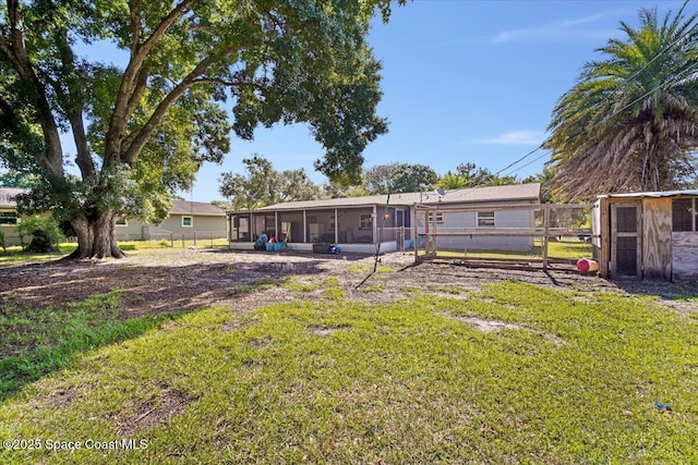13 Lee St, Cocoa, FL 32926 - view of yard with a sunroom, exterior structure, and an outdoor structure