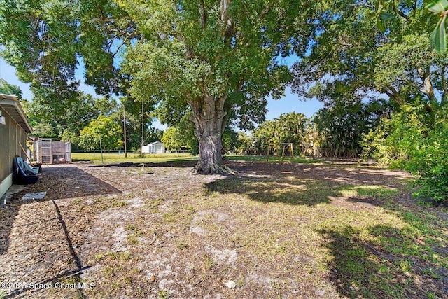 13 Lee St, Cocoa, FL 32926 - view of yard featuring an outdoor structure and view of wooded area