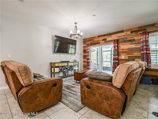 9025 106th Ave, Vero Beach, FL 32967 - living area featuring a chandelier, light tile patterned flooring, wood walls, and a textured ceiling