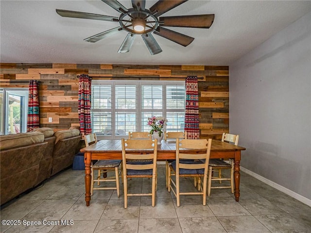 9025 106th Ave, Vero Beach, FL 32967 - dining area featuring wooden walls, ceiling fan, and a textured ceiling