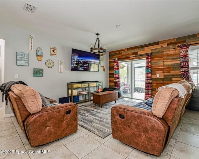 9025 106th Ave, Vero Beach, FL 32967 - living room with plenty of natural light, light tile patterned floors, and a chandelier