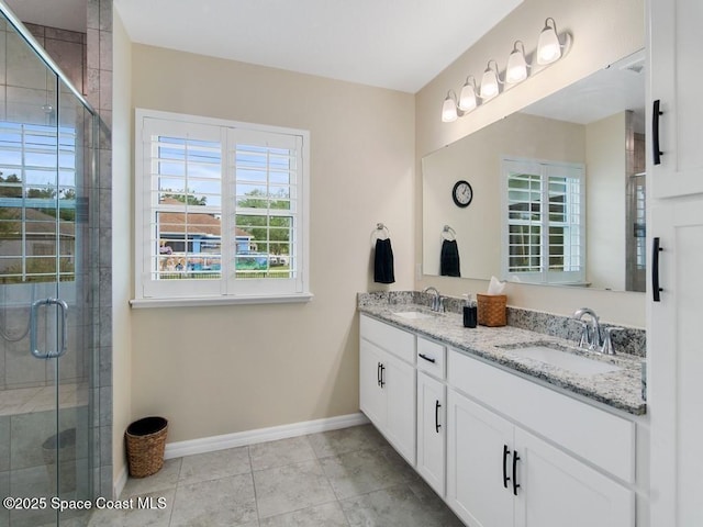 9025 106th Ave, Vero Beach, FL 32967 - bathroom featuring double vanity, a shower stall, and tile patterned flooring
