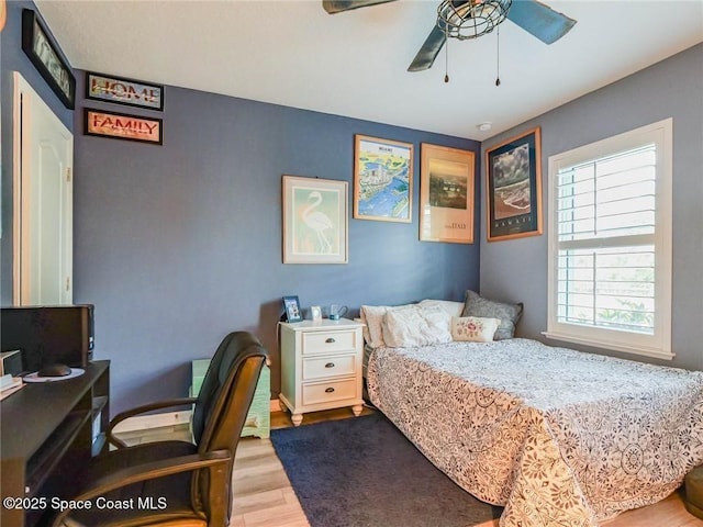 9025 106th Ave, Vero Beach, FL 32967 - bedroom featuring wood finished floors, a desk, and a ceiling fan