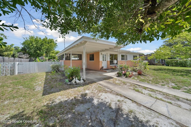 1938 Madison Ave, Melbourne, FL 32935 - view of front of property featuring a carport, concrete driveway, and stucco siding