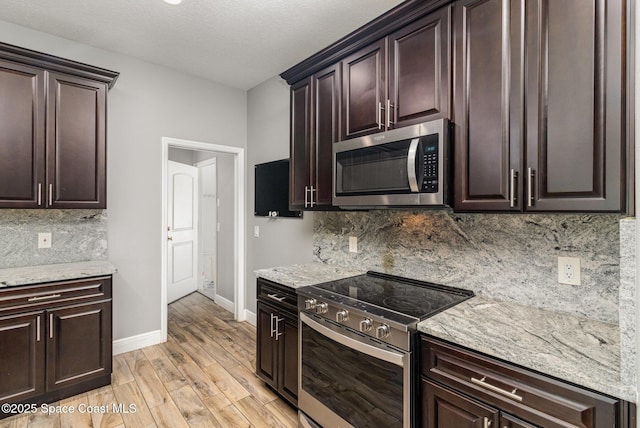 3735 Crista Jean Ave, Grant-Valkaria, FL 32909 - kitchen with stainless steel appliances, decorative backsplash, light wood finished floors, and dark brown cabinets