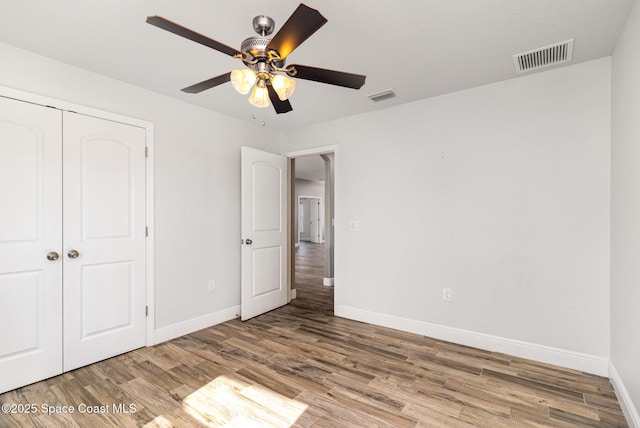 3735 Crista Jean Ave, Grant-Valkaria, FL 32909 - unfurnished bedroom with wood finished floors, a closet, and ceiling fan