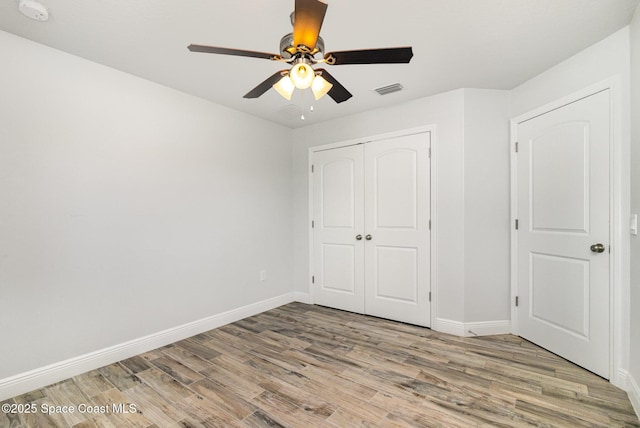 3735 Crista Jean Ave, Grant-Valkaria, FL 32909 - unfurnished bedroom with light wood-style floors, a closet, and a ceiling fan