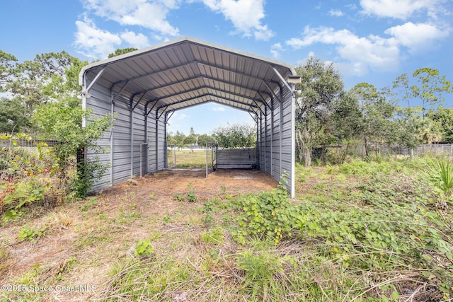 3735 Crista Jean Ave, Grant-Valkaria, FL 32909 - view of parking featuring a carport and dirt driveway