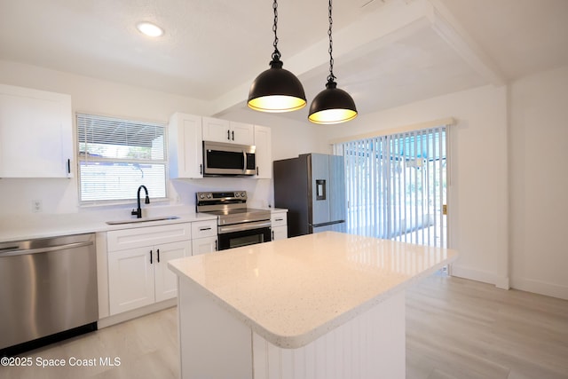 1810 Dixon Blvd, Cocoa, FL 32922 - kitchen with appliances with stainless steel finishes, a center island, decorative light fixtures, white cabinets, and light stone counters