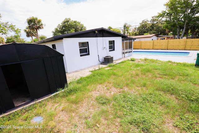 1810 Dixon Blvd, Cocoa, FL 32922 - rear view of property with a fenced backyard and a storage unit