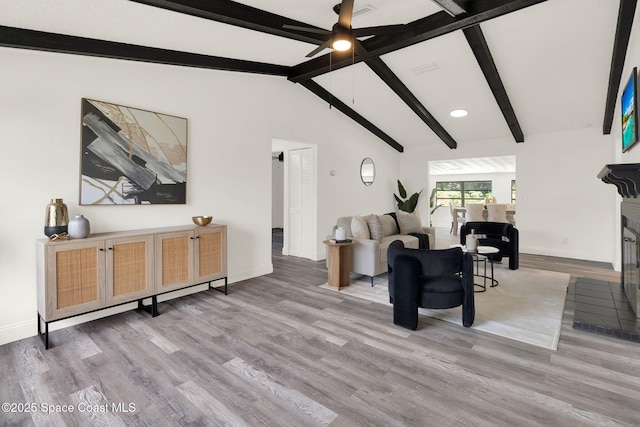5685 Jamaica Rd, Cocoa, FL 32927 - living area with ceiling fan, wood finished floors, and a glass covered fireplace