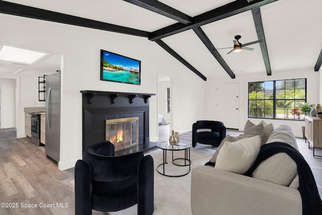 5685 Jamaica Rd, Cocoa, FL 32927 - living area featuring a glass covered fireplace, light wood finished floors, and a ceiling fan