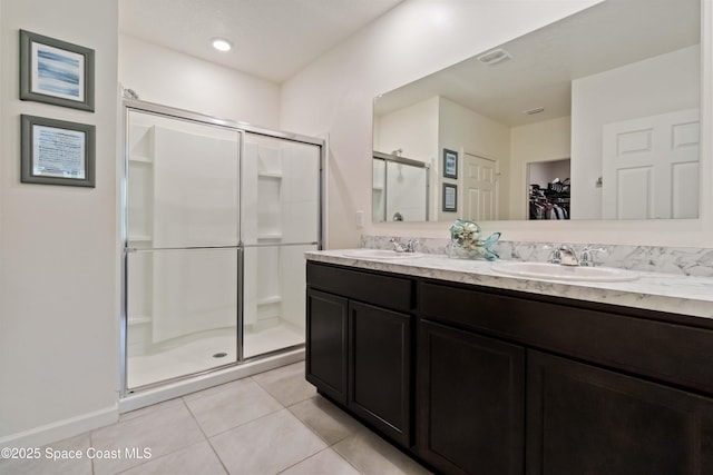 1809 Morely Dr, Cocoa, FL 32926 - bathroom with a shower stall, double vanity, a spacious closet, and tile patterned flooring