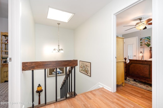 1100 SE Mitchell Ave Unit 204, Port St Lucie, FL 34952 - hallway featuring an upstairs landing, a skylight, and wood finished floors