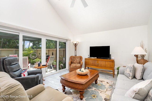 1100 SE Mitchell Ave Unit 204, Port St Lucie, FL 34952 - living area with light wood finished floors, a ceiling fan, and high vaulted ceiling