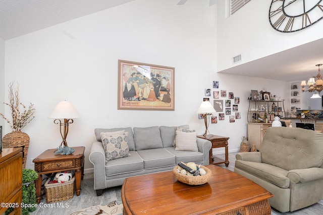 1100 SE Mitchell Ave Unit 204, Port St Lucie, FL 34952 - living room with wood finished floors, high vaulted ceiling, and a chandelier
