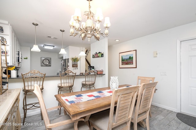 1100 SE Mitchell Ave Unit 204, Port St Lucie, FL 34952 - dining area with light wood finished floors and a chandelier