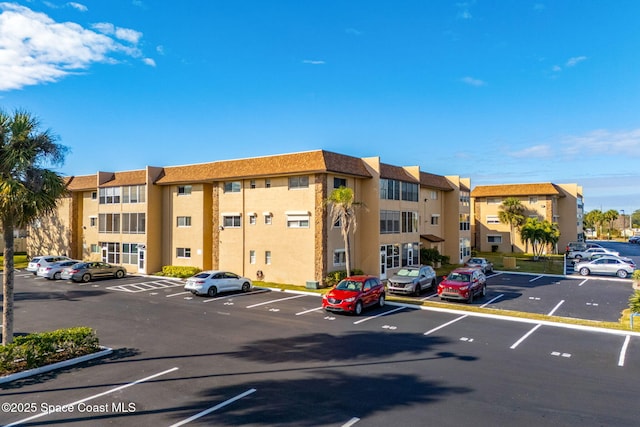 3210 N Harbor City Blvd Unit 316, Melbourne, FL 32935 - view of apartment building / complex featuring uncovered parking