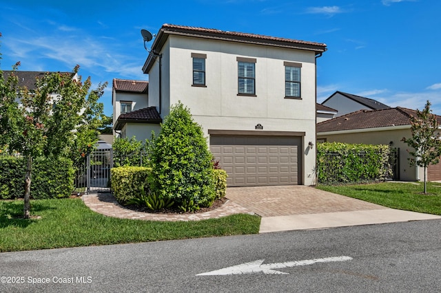 2225 Framura Ln, Melbourne, FL 32940 - mediterranean / spanish-style home with decorative driveway, a garage, stucco siding, and a tile roof