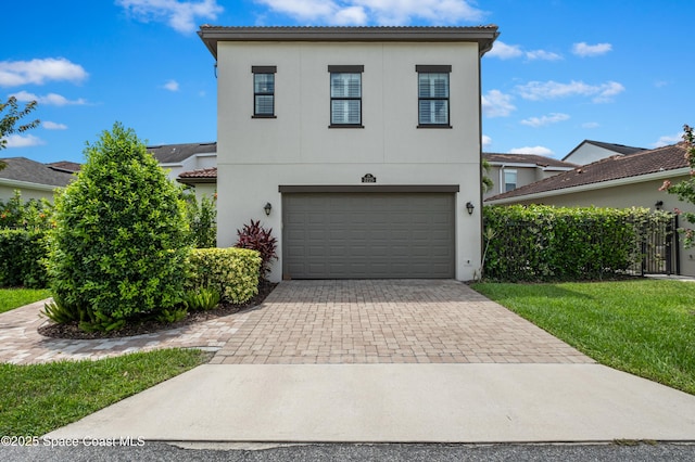 2225 Framura Ln, Melbourne, FL 32940 - view of front of house with decorative driveway, an attached garage, stucco siding, and a tiled roof