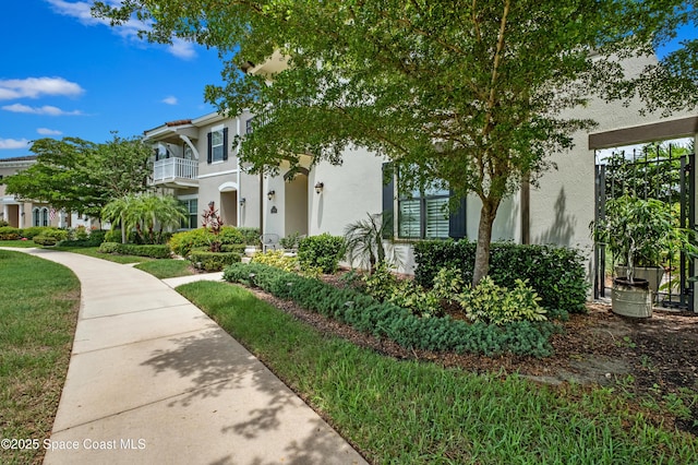 2225 Framura Ln, Melbourne, FL 32940 - view of front of property featuring stucco siding and a balcony