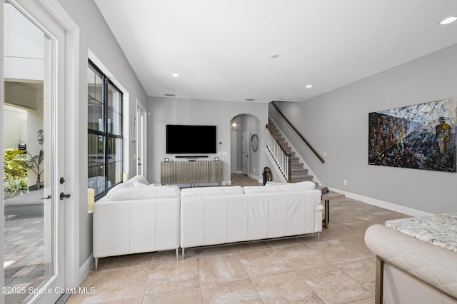 2225 Framura Ln, Melbourne, FL 32940 - living area with arched walkways, stairway, recessed lighting, and light tile patterned flooring