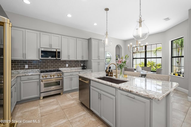 2225 Framura Ln, Melbourne, FL 32940 - kitchen with appliances with stainless steel finishes, gray cabinets, backsplash, recessed lighting, and a chandelier