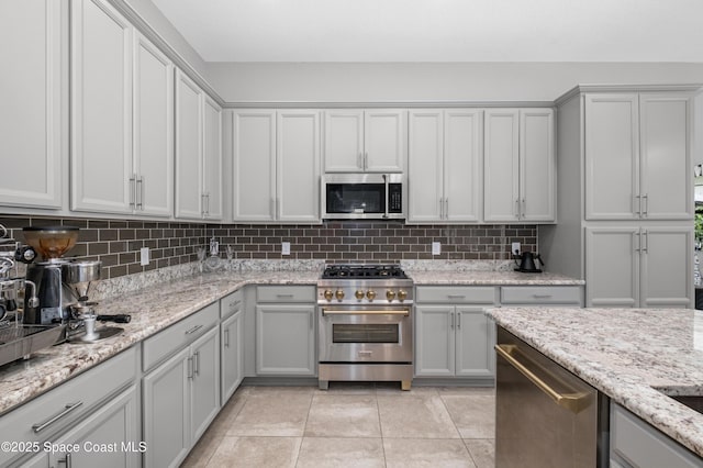 2225 Framura Ln, Melbourne, FL 32940 - kitchen featuring stainless steel appliances, gray cabinets, and decorative backsplash