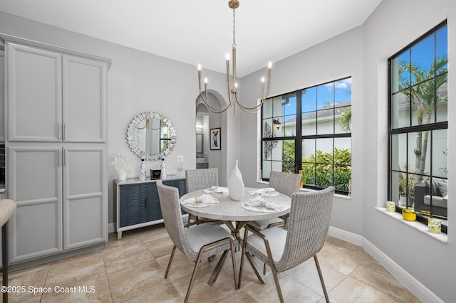 2225 Framura Ln, Melbourne, FL 32940 - dining area featuring light tile patterned floors, a chandelier, and arched walkways
