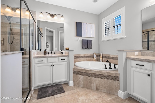 2225 Framura Ln, Melbourne, FL 32940 - bathroom with a stall shower, two vanities, a garden tub, and tile patterned floors