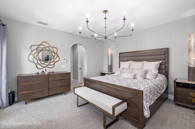 2225 Framura Ln, Melbourne, FL 32940 - bedroom with arched walkways, light carpet, and a chandelier