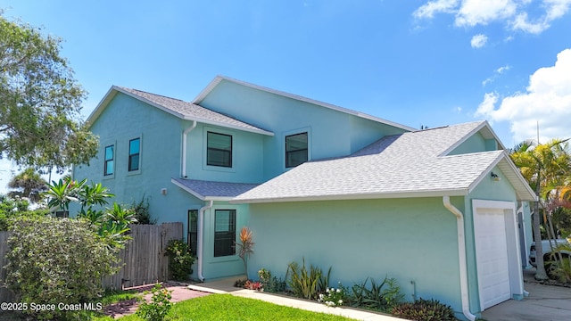 47 Anchor Dr, Indian Harbour Beach, FL 32937 - traditional-style home featuring stucco siding, a garage, and a shingled roof