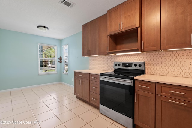 47 Anchor Dr, Indian Harbour Beach, FL 32937 - kitchen with electric range, decorative backsplash, light countertops, and open shelves